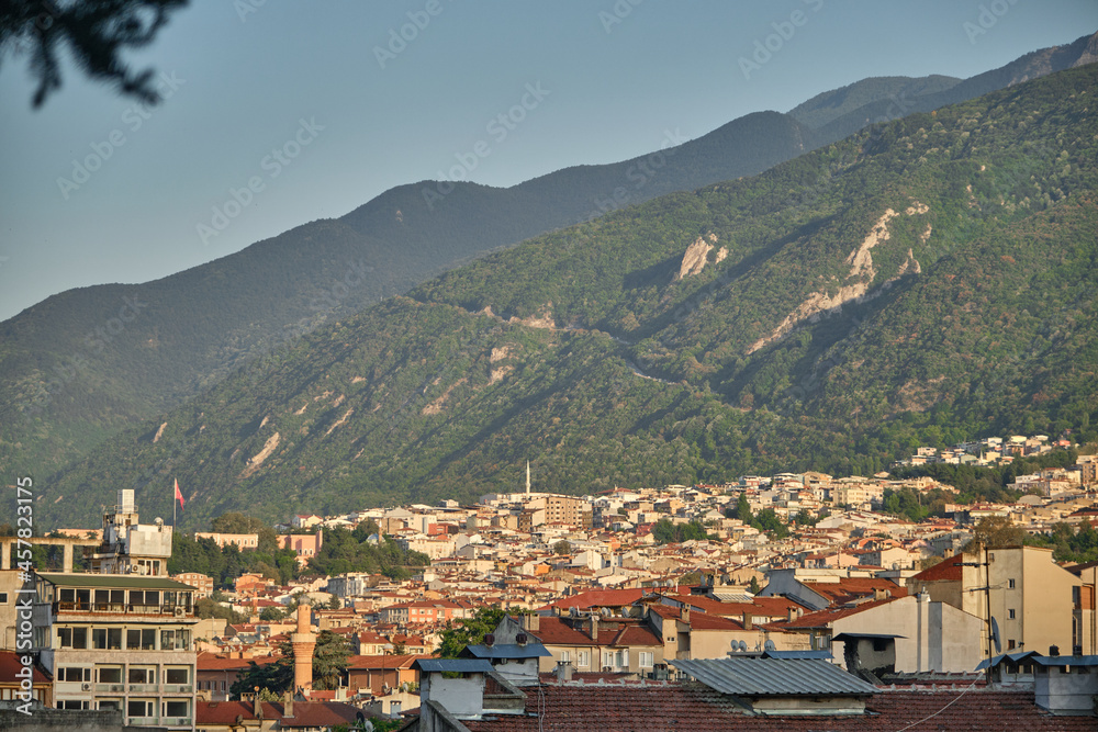 Bursa. Turkey. Ancient city view of old town Bursa during sunset and sun lights on houses. City established mountain food of uludag (grand mountain)