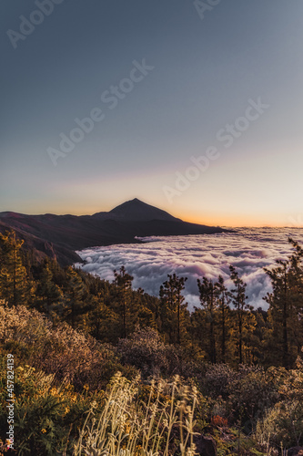 Mountain landscape with a volcano at sunset and clouds