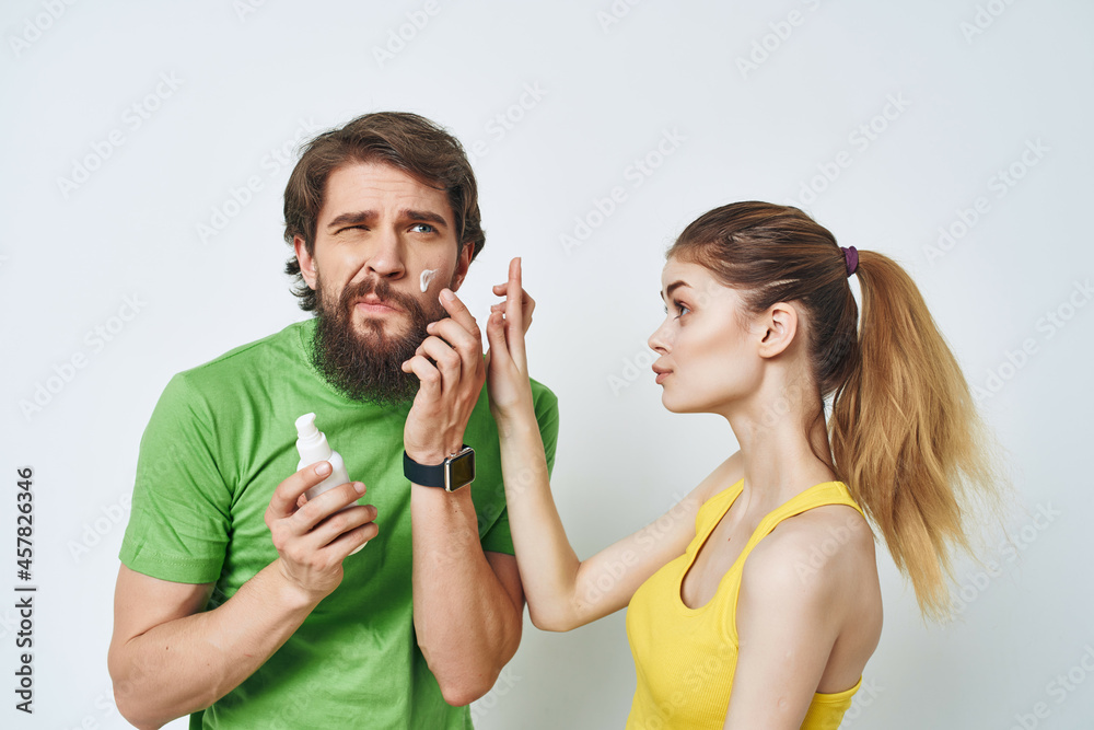 bearded man next to woman shaving facial in bathroom bearded man next to woman shaving facial in bathroom