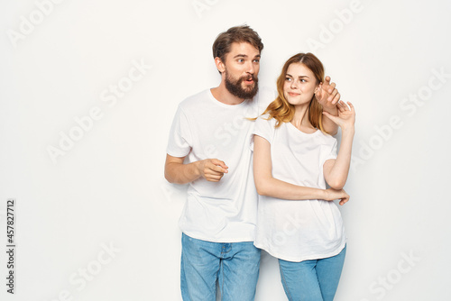 cheerful young couple in white t-shirts casual clothes fashion communication
