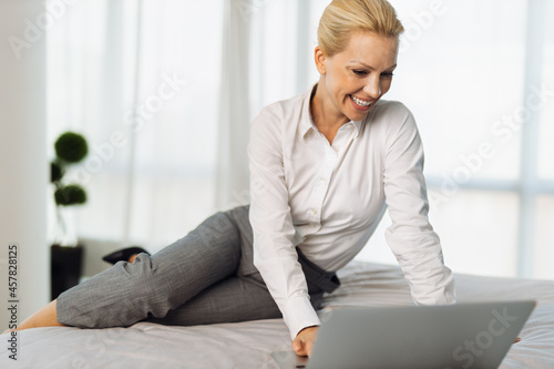 Beautiful businesswoman using computer in a hotel room