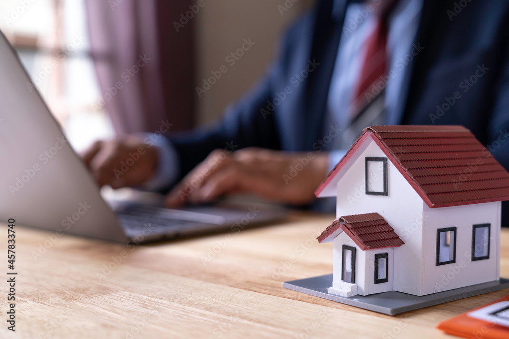 Man signing a contract when buying a new house Purchase agreement for ours with model home, Man sign a home insurance policy on home loans, Businessman signing contract insurance, Real estate concept Man signing a contract when buying a new house Purchase agreement for ours with model home, Man sign a home insurance policy on home loans, Businessman signing contract insurance, Real estate concept