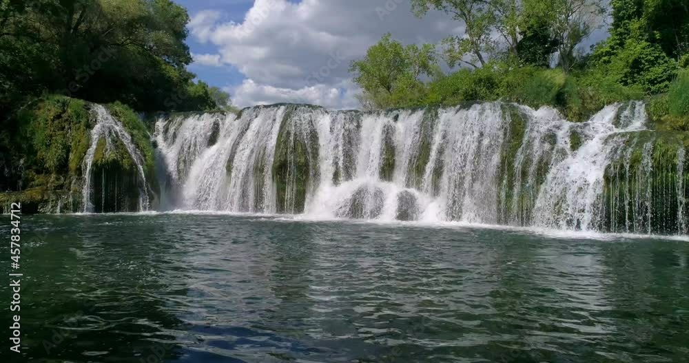 A forward moving shot towards a beautiful waterfall-slow motion A forward moving shot towards a beautiful waterfall-slow motion