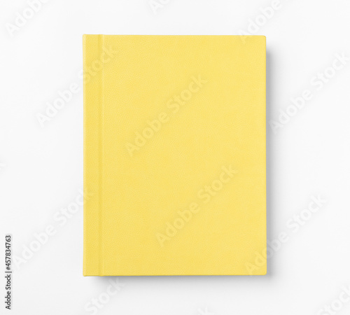 Yellow hardcover book, isolated on white background. Top view