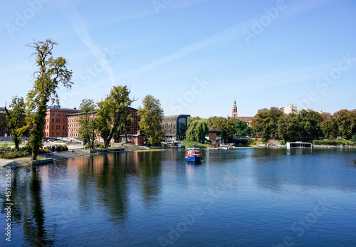 colorful wooden tourist boat cruise on the Brda River in the heart of downtown Bygdoszcz