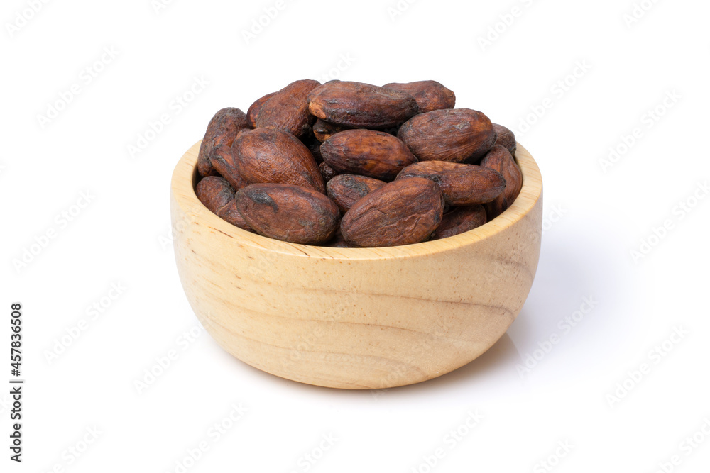 cocoa beans in a wooden bowl isolated on white