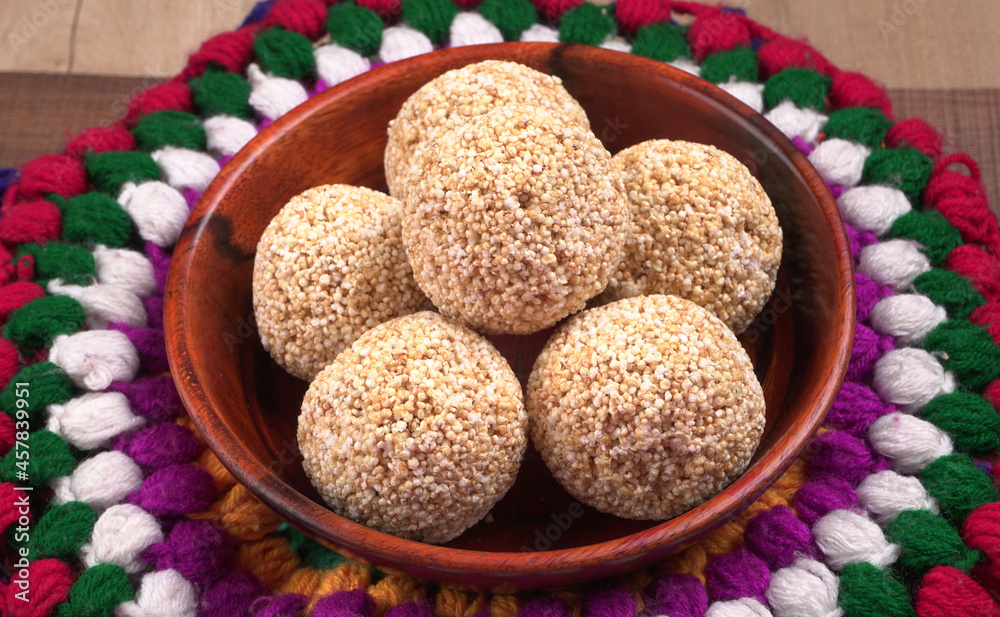 Amarnath seed, Cholai or Rajgira laddo, Also in cube shape called chikki or cake form, Indian sweet and healthy food served in a plate and bowl. Selective focus. Amarnath seed, Cholai or Rajgira laddo, Also in cube shape called chikki or cake form, Indian sweet and healthy food served in a plate and bowl. Selective focus.