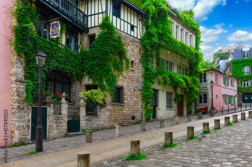 Cozy street in quarter Montmartre in Paris, France. Architecture and landmarks of Paris. Postcard of Paris