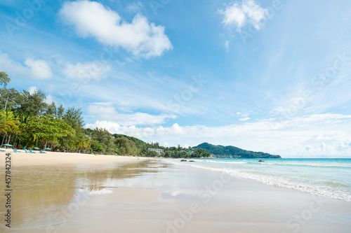 Landscape clean sea white clouds soft daylight.Blue sea and sky famous beach.Umbrella on beach Coconut palm trees in islands.