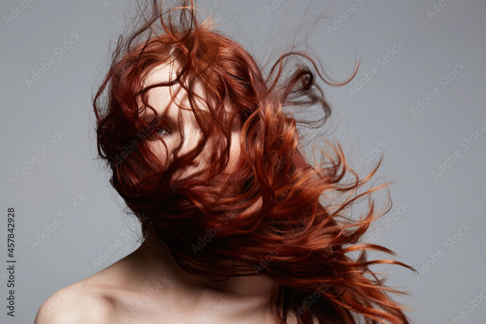 Naklejka premium beautiful young woman with curly red hair