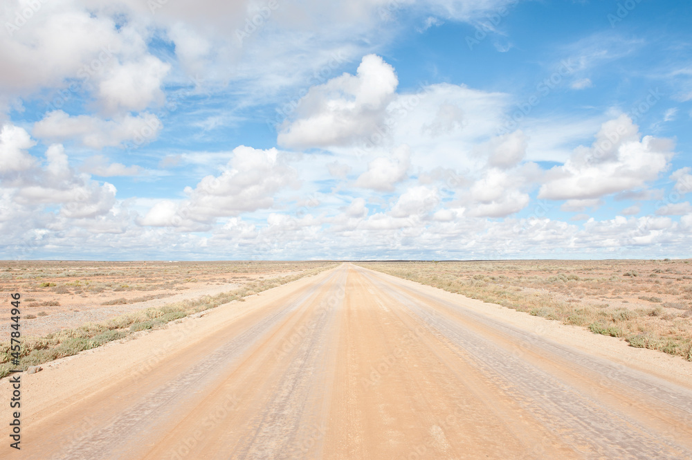 Empty straight dirt road leads to horizon Empty straight dirt road leads to horizon