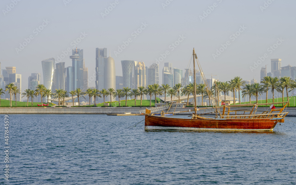 Qatar skyline along with a qatar traditional dhow. selective focus