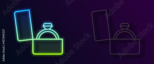 Glowing neon line Diamond engagement ring in a box icon isolated on black background. Vector