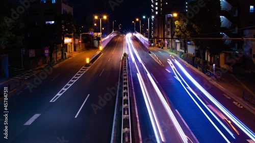 A night timelapse of the downtown street in Tokyo wide shot panning
