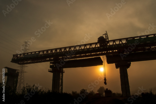 Silhouette Beam Launcher Gantry crane for railway bridge on site construction, Thailand. photo