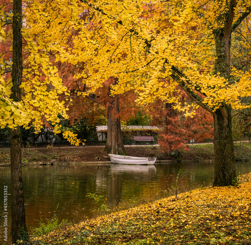Small boat on a lake in Jardin Public park in Bordeaux in Autumn during the month of October