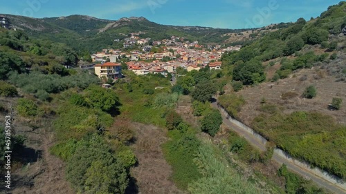 The mesmerizing view of Santu Lussurgiu town surrounded by forested mountains in Sardinia in 4K photo