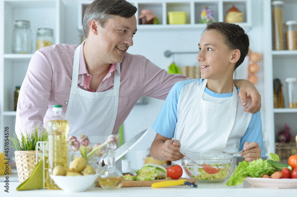 Close up portrait of father and son cooking Close up portrait of father and son cooking
