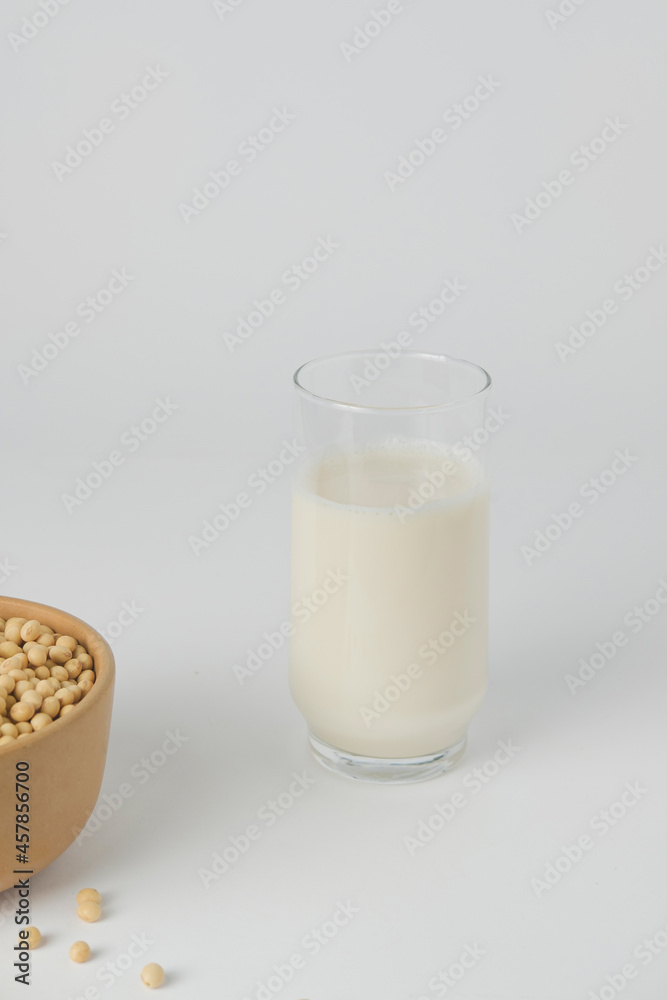 Soy vegetable milk in the glass and soybeans. Homemade. Isolated and white background Soy vegetable milk in the glass and soybeans. Homemade. Isolated and white background