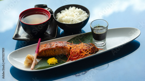 Food set ready to eat on table. salmon grill, plain rice and soup. set as japanese food