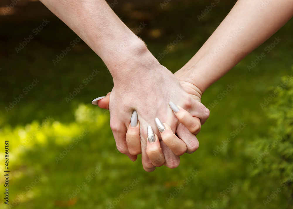 man and woman hold hands. hands closeup man and woman hold hands. hands closeup