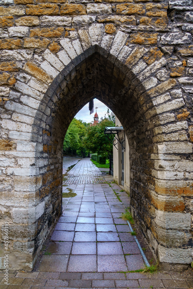 Entrance in the medieval wall with stone arch in Tallinn Estonia.
