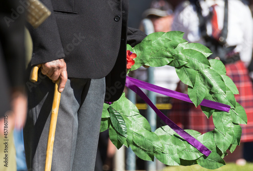 Detail of elderly male digger laying a wreath on ANZAC Day photo