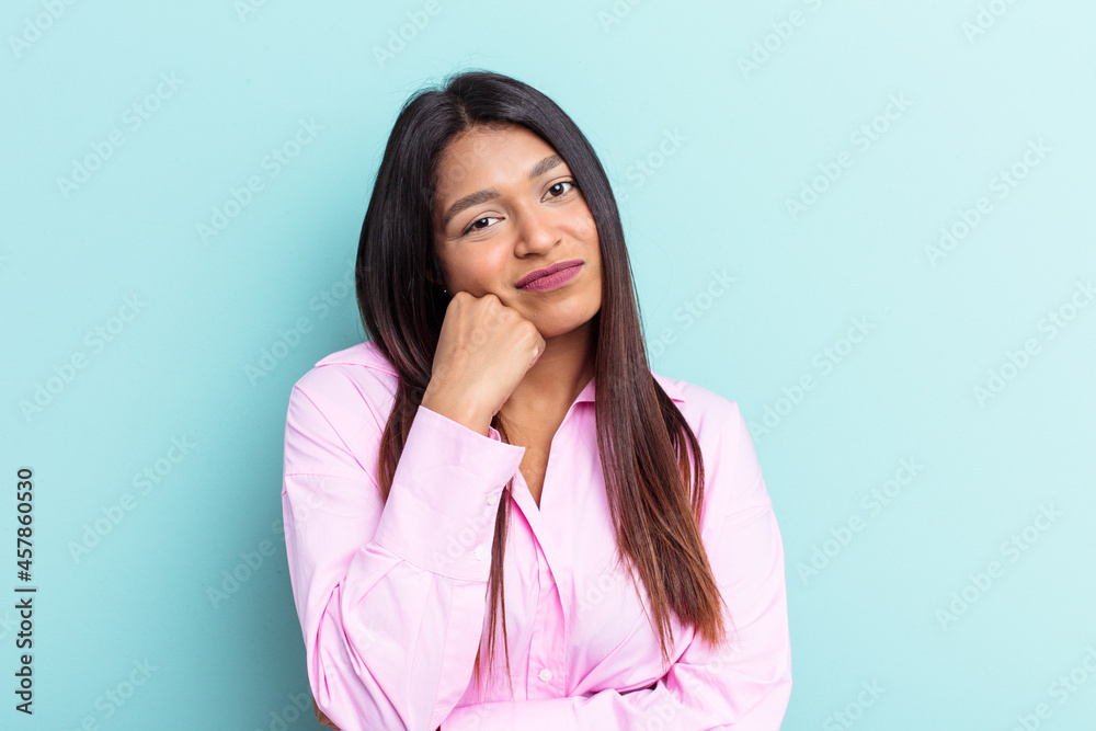 Young Venezuelan woman isolated on blue background who feels sad and pensive, looking at copy space. Young Venezuelan woman isolated on blue background who feels sad and pensive, looking at copy space.
