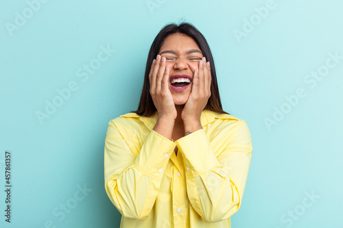 Young Venezuelan woman isolated on blue background whining and crying disconsolately.