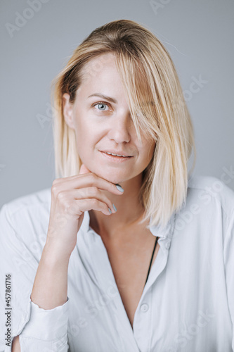 portrait of a young and energetic woman in her early forties with beautiful healthy skin and teeth.