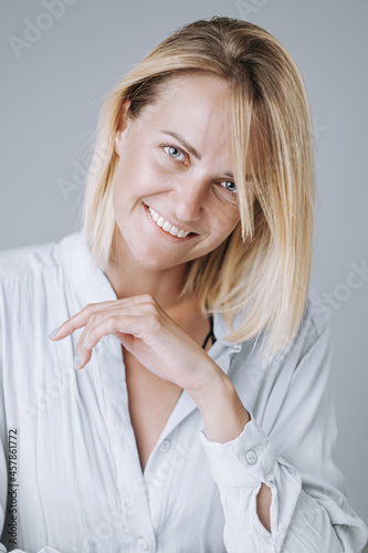 portrait of a young and energetic woman in her early forties with beautiful healthy skin and teeth.
