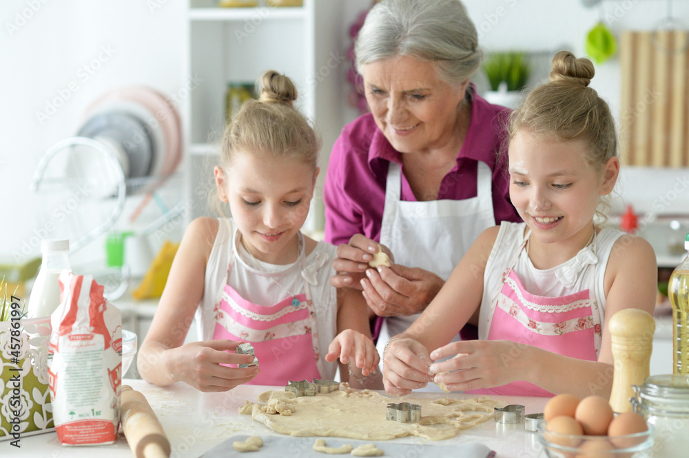 Portrait of cute girls and mother baking Portrait of cute girls and mother baking
