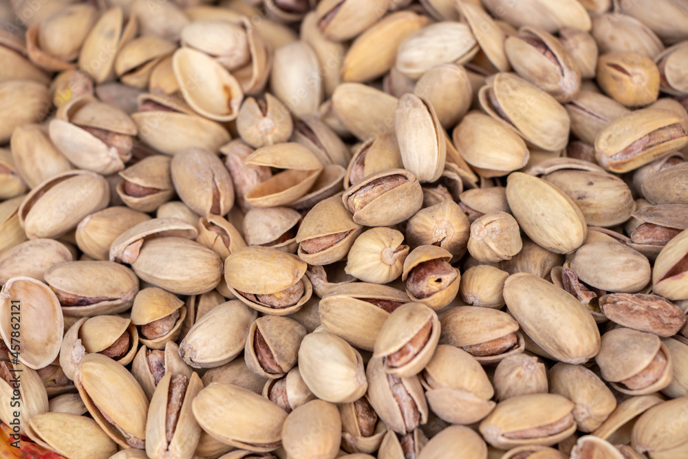 Roasted and salted pistachios in shell texture, background Roasted and salted pistachios in shell texture, background