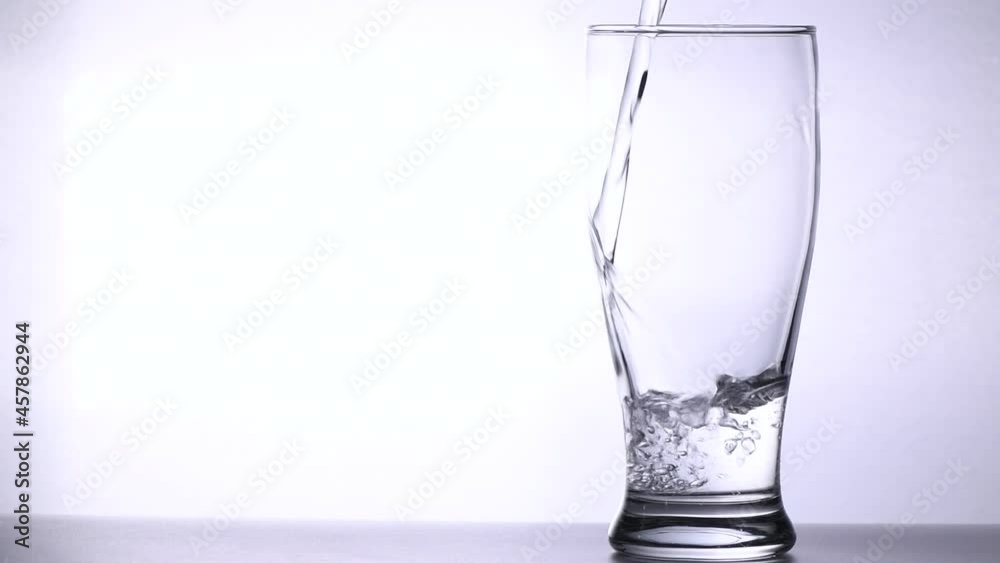 Pour water into empty glass isolated on white background, health care concept Pour water into empty glass isolated on white background, health care concept