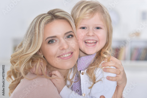 Close up portrait of little cute girl with mother