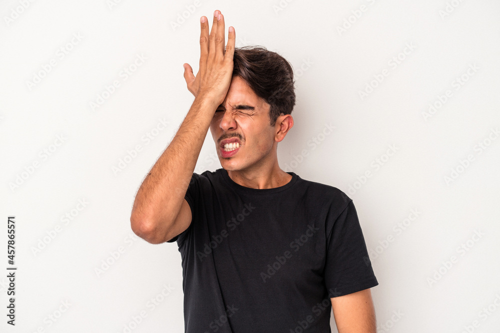 Young mixed race man isolated on white background forgetting something, slapping forehead with palm and closing eyes. Young mixed race man isolated on white background forgetting something, slapping forehead with palm and closing eyes.