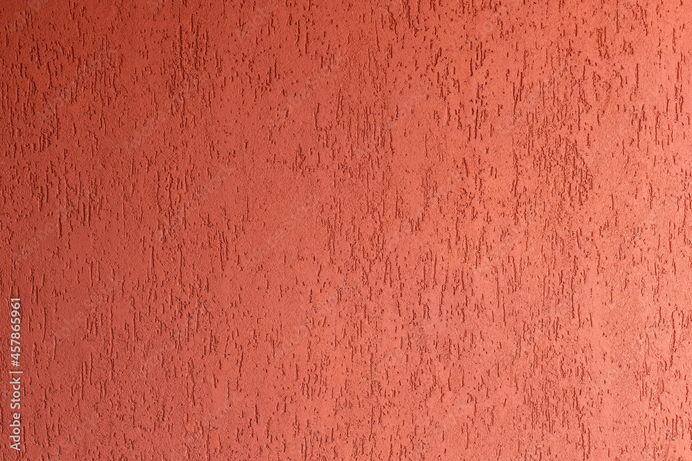 Surface of wall with decorative red plaster. house facade with spatula technique structure. selective focus Surface of wall with decorative red plaster. house facade with spatula technique structure. selective focus