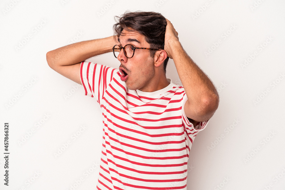Young mixed race man isolated on white background screaming, very excited, passionate, satisfied with something. Young mixed race man isolated on white background screaming, very excited, passionate, satisfied with something.