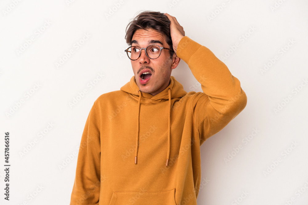 Young mixed race man isolated on white background being shocked, she has remembered important meeting. Young mixed race man isolated on white background being shocked, she has remembered important meeting.