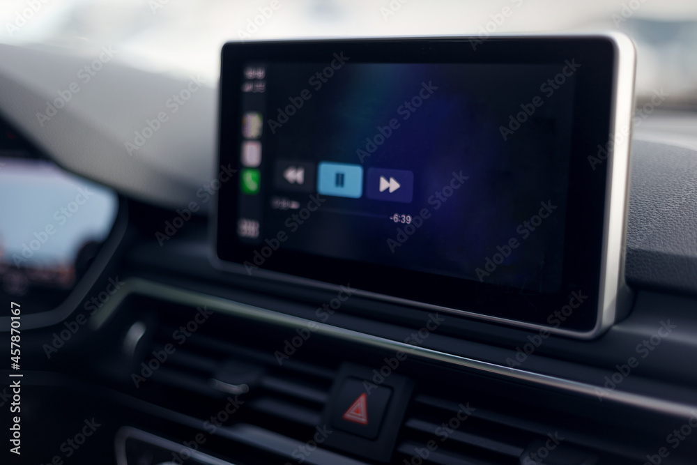 Car multimedia system. Glowing beautiful dashboard of a modern expensive car. The interior of the car. The foreground is blurred. Modern car interior details. Selective focus Car multimedia system. Glowing beautiful dashboard of a modern expensive car. The interior of the car. The foreground is blurred. Modern car interior details. Selective focus