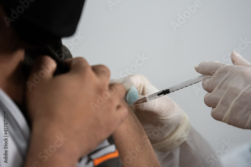 Doctors vaccinate the general public  doctor vaccinating covid 19 to the group of workers   inject a Vaccine Covid19 vaccination for covid 19 for the group of workers