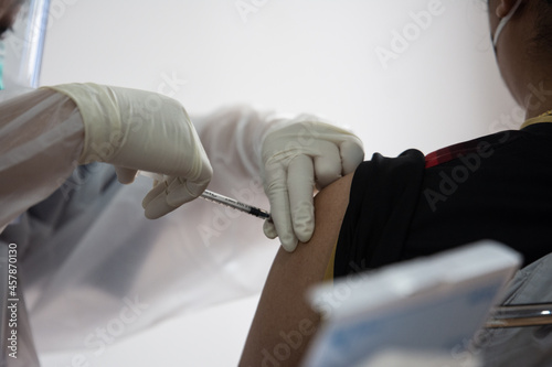 Doctors vaccinate the general public, doctor vaccinating covid 19 to the group of workers , inject a Vaccine Covid19 vaccination for covid 19 for the group of workers