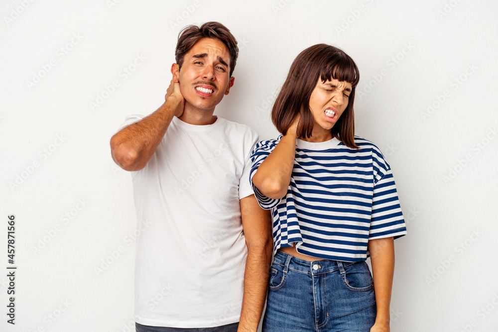 Young mixed race couple isolated on white background having a neck pain due to stress, massaging and touching it with hand. Young mixed race couple isolated on white background having a neck pain due to stress, massaging and touching it with hand.