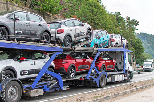 Truck carrying cars. Automotive and transport industry - concept. No logo or brand.