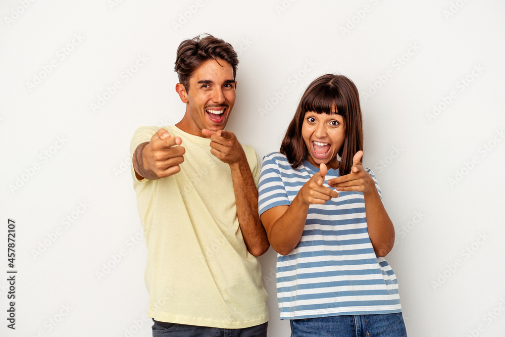 Young mixed race couple isolated on white background cheerful smiles pointing to front. Young mixed race couple isolated on white background cheerful smiles pointing to front.