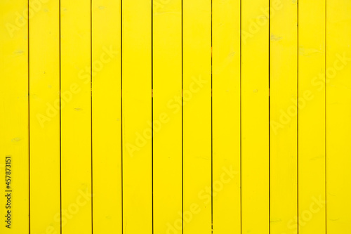 Yellow wood texture. Street fence made of wood photo