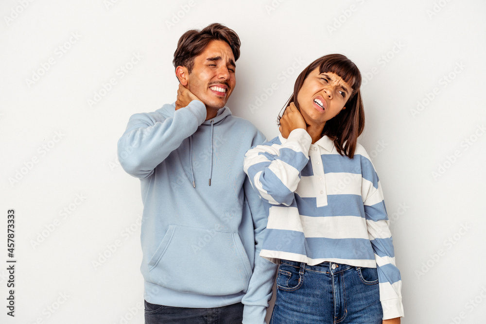 Young mixed race couple isolated on white background suffering neck pain due to sedentary lifestyle. Young mixed race couple isolated on white background suffering neck pain due to sedentary lifestyle.