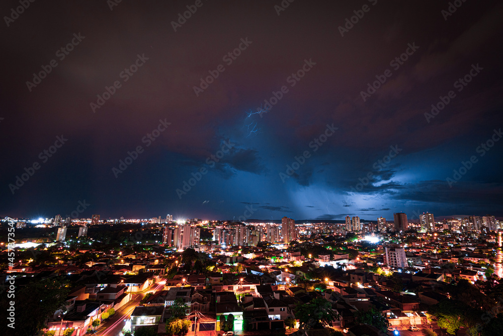 Lightning Storm Over Ribeirao Preto City in Brazil. Thunder blue light on a summer night concept image.
