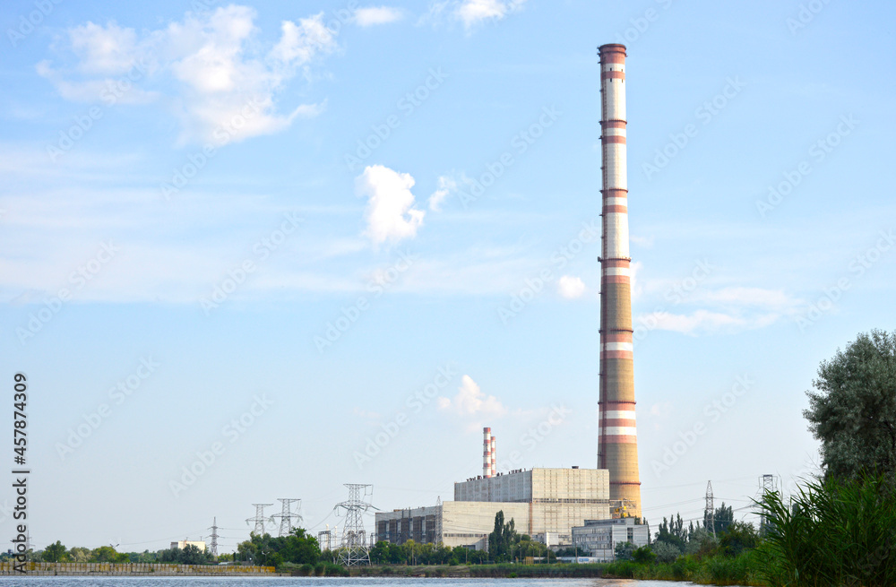 view from a distance to the thermal power plant. you can see the station building, tall pipes and high-voltage lines