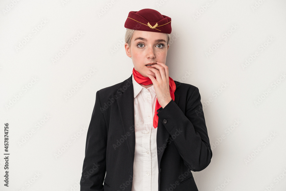 Young air hostess caucasian woman isolated on white background biting fingernails, nervous and very anxious.